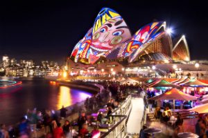 The sails of the Sydney Opera house painted with faces during Vivid