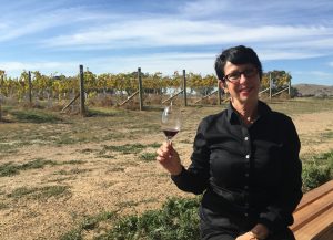 Enjoying a wine beside the vines