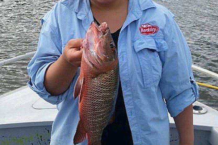 Rhonda and her Mangrove Jack while estuary fishing