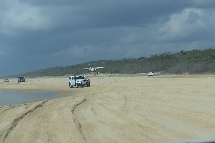 Plane landing on 75 Mile Beach